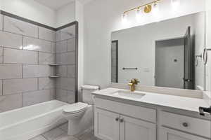 Full bathroom with shower / tub combination, vanity, and light tile patterned floors