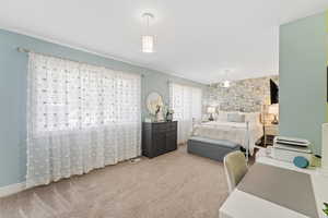 Bedroom with carpet flooring and wallpapered walls