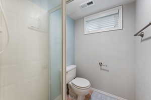 Bathroom featuring a stall shower and tile patterned flooring