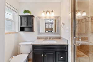Bathroom featuring vanity and a shower stall