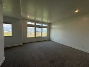 Carpeted empty room featuring baseboards and recessed lighting