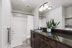 Full Master bathroom featuring shower / tub combo with curtain, vanity, and light wood finished floors
