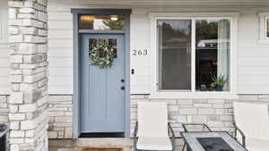 Entrance to property featuring stone siding