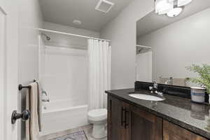 Full bathroom featuring shower / tub combo, vanity, and light wood-type flooring
