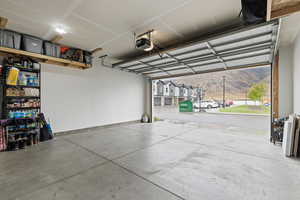 Garage featuring a mountain view and a garage door opener