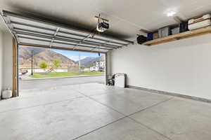 Garage with a mountain view and a garage door opener