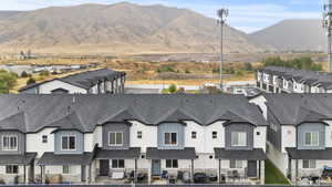 View of mountain backdrop featuring nearby suburban area