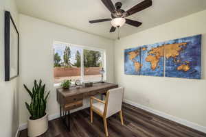 Office space featuring dark wood-style flooring and ceiling fan