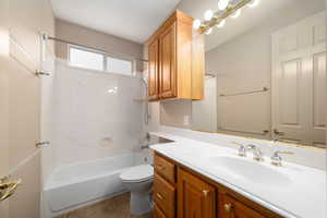 Full bathroom with shower / bath combination, vanity, and light tile patterned flooring