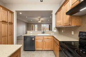 Kitchen featuring black / electric stove, recessed lighting, brown cabinetry, dishwashing machine, and extractor fan