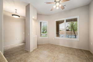 Spare room with a ceiling fan and light tile patterned flooring