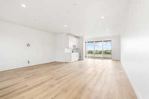 Unfurnished living room featuring light wood-style flooring and recessed lighting