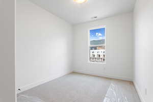 Unfurnished room with light colored carpet and baseboards