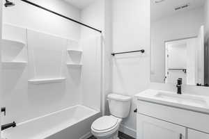 Bathroom featuring vanity and shower / washtub combination