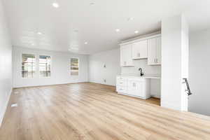 Unfurnished living room with recessed lighting and light wood-style floors
