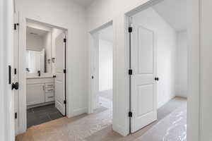 Hall with dark carpet and baseboards