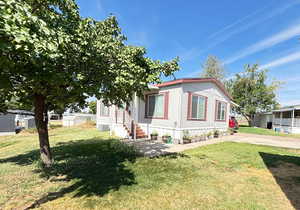 View of home's exterior with a yard