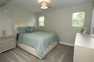 Carpeted bedroom featuring baseboards