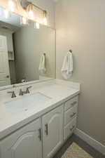 Bathroom featuring vanity and baseboards