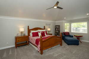 Carpeted bedroom with ceiling fan, crown molding, lofted ceiling, and recessed lighting