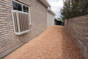 View of property exterior with brick siding