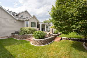 View of grassy yard featuring a patio