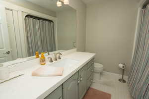 Full bath featuring vanity and a shower with curtain
