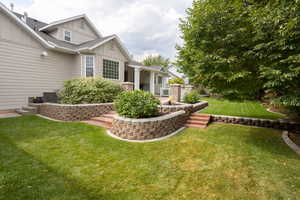 View of green lawn with a patio