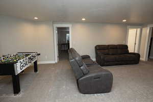 Recreation room featuring recessed lighting, carpet flooring, and a textured ceiling