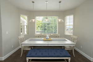 Dining area featuring dark wood-type flooring