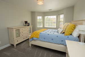 Bedroom featuring dark carpet