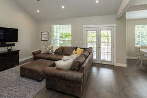 Living area featuring recessed lighting and dark wood-type flooring