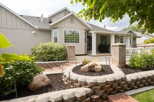 View of front facade featuring board and batten siding and a shingled roof