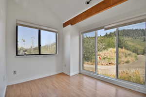 Empty room with light wood-style flooring and baseboards