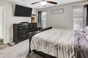 Bedroom featuring light carpet and a ceiling fan