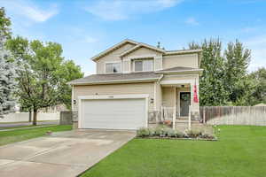 View of front of home featuring a garage, concrete driveway, a porch, and roof with shingles