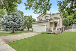 View of front facade with concrete driveway and a garage