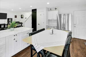 Dining space with dark wood-style floors and recessed lighting