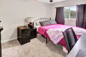 Bedroom featuring light colored carpet and ceiling fan
