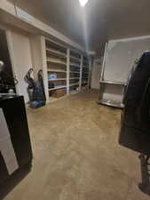 Below grade area featuring black fridge