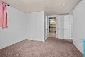 Spare room featuring light carpet and baseboards