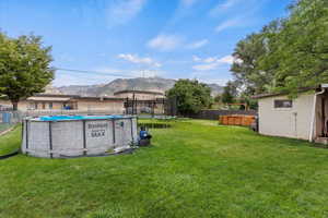 View of yard featuring a mountain view and a trampoline