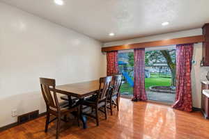 Dining space with light wood-style floors and recessed lighting