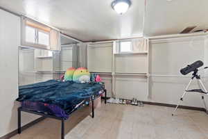 Game room with light tile patterned floors and baseboards