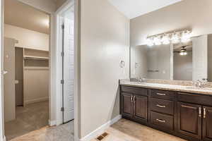 primary en suite bathroom with walk-in closet