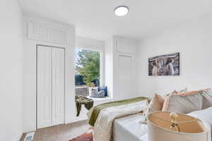 Carpeted bedroom featuring two closets
