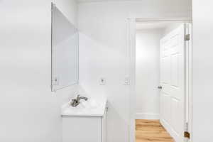 Bathroom featuring vanity and light wood finished floors