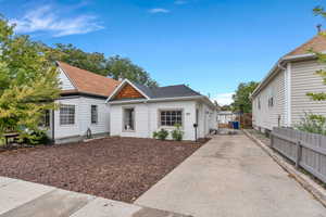 View of front of property with a shingled roof and driveway