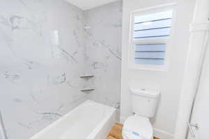 Full bathroom with  shower combination and toilet