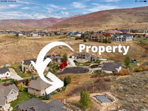 Aerial view of residential area featuring a mountain backdrop